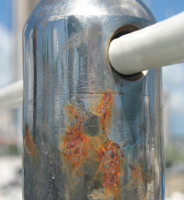 Crevice corrosion cracks near top of stanchion rusting